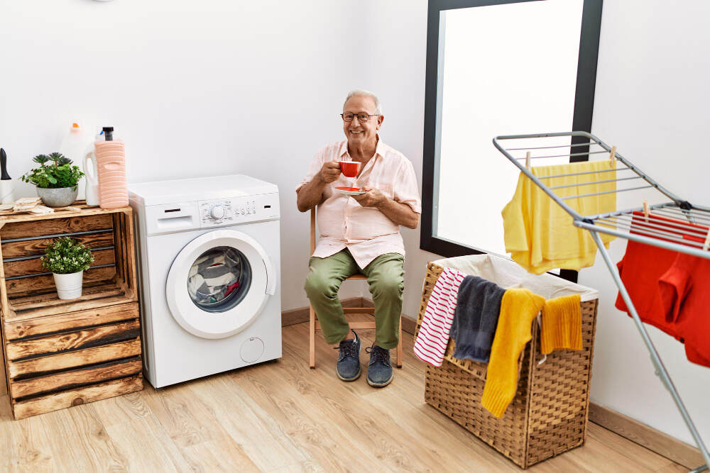 Aged old citizen drinking coffee in laundry shop